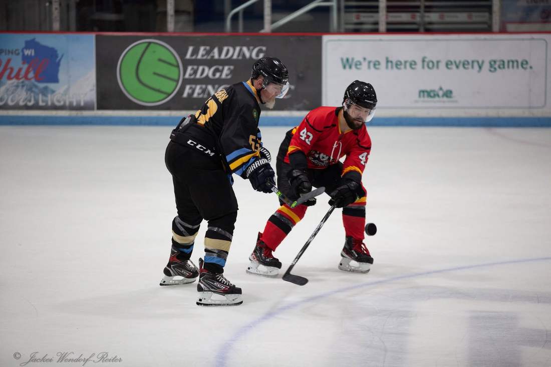 Warriors and Comrades players on a faceoff circle