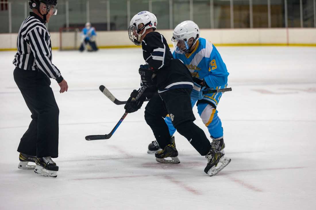 Warriors #19 battles for position on a faceoff