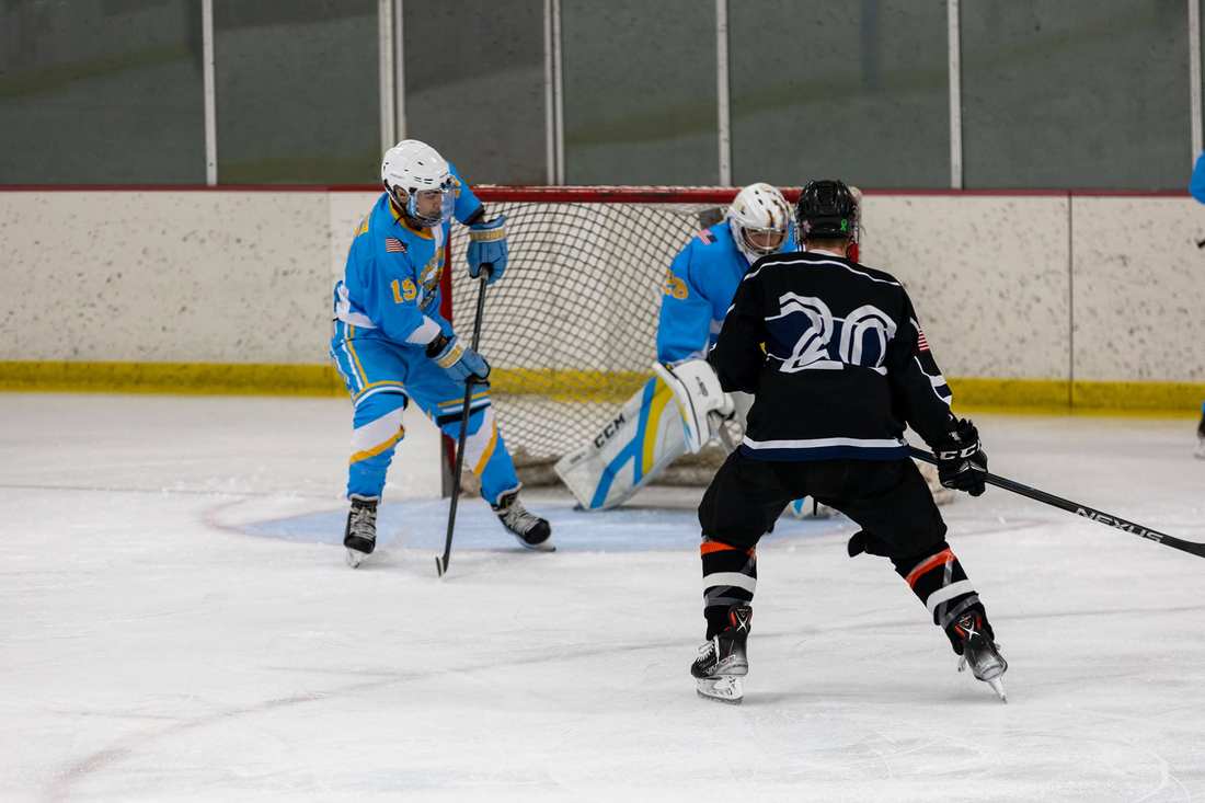 Warriors #19 defends in front of goalie #28