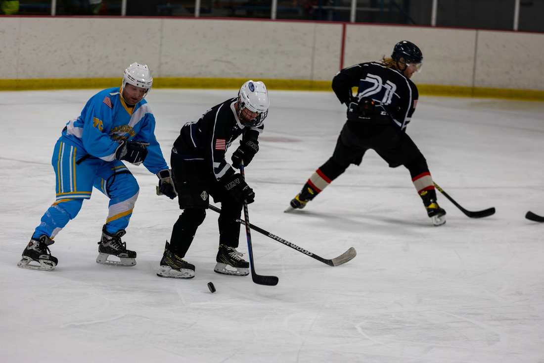 Warriors skater closes in on a puck carrier